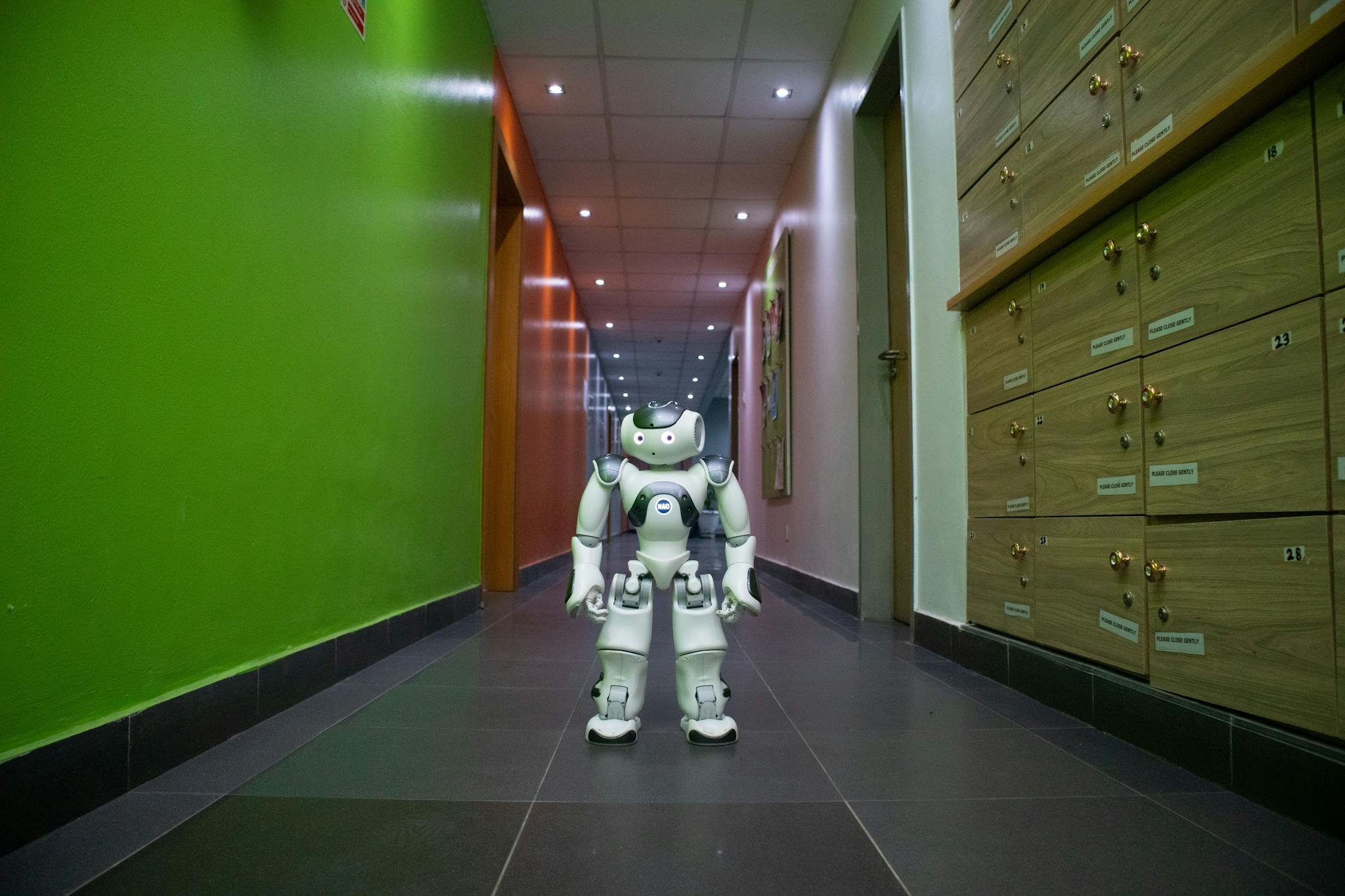 A humanoid robot stands in a vibrant, modern hallway in Lagos, Nigeria.