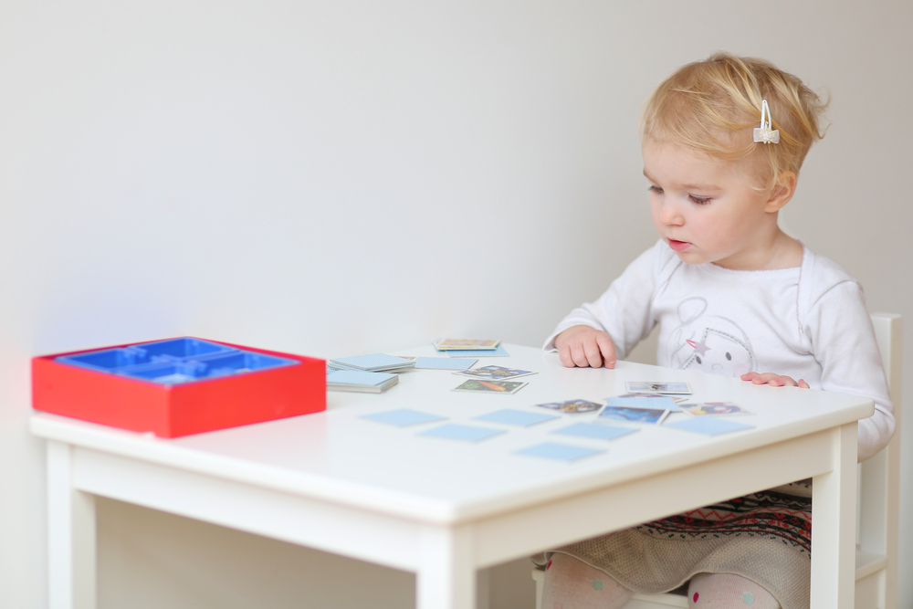 adorable,blonde,toddler,girl,playing,memory,game,sitting,at,little